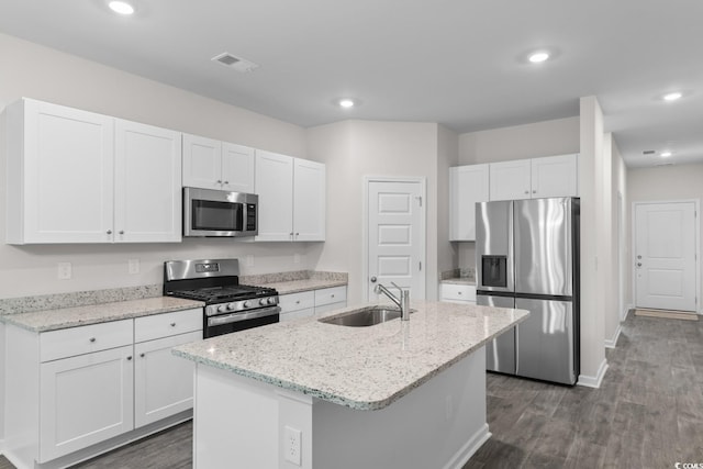 623 Harrison Mill St Unit 623, Myrtle Beach, SC 29579 - kitchen featuring appliances with stainless steel finishes, white cabinetry, dark wood finished floors, a center island with sink, and light stone countertops