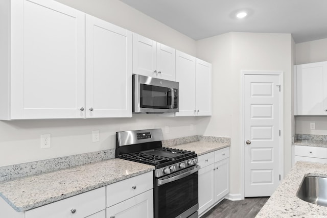 623 Harrison Mill St Unit 623, Myrtle Beach, SC 29579 - kitchen with stainless steel appliances, white cabinets, wood finished floors, light stone countertops, and recessed lighting