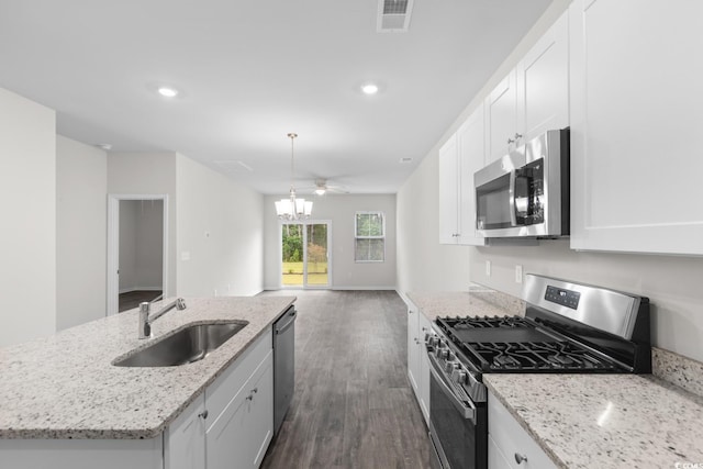 623 Harrison Mill St Unit 623, Myrtle Beach, SC 29579 - kitchen featuring appliances with stainless steel finishes, dark wood-style flooring, white cabinetry, a center island with sink, and recessed lighting