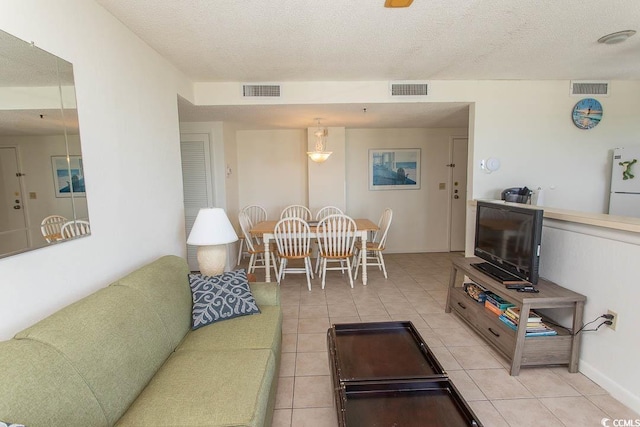 5905 S Kings Hwy Unit 1414, Myrtle Beach, SC 29575 - living room featuring light tile patterned floors and a textured ceiling