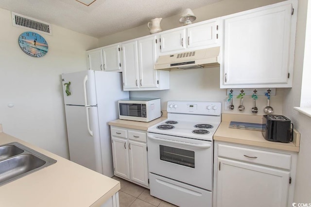 5905 S Kings Hwy Unit 1414, Myrtle Beach, SC 29575 - kitchen featuring under cabinet range hood, white appliances, white cabinets, light countertops, and light tile patterned floors