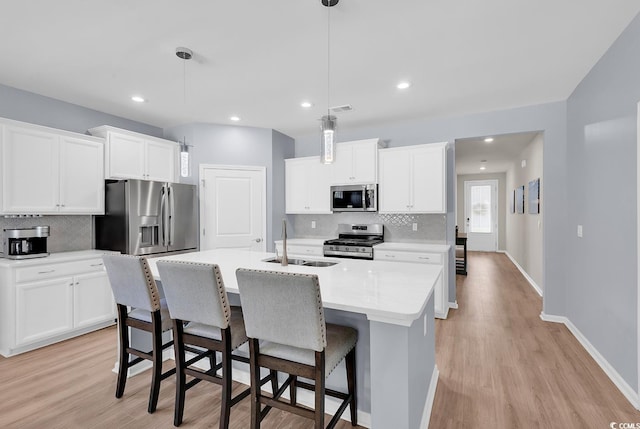 520 Cattle Drive Cir, Myrtle Beach, SC 29588 - kitchen with stainless steel appliances, tasteful backsplash, light wood-style flooring, an island with sink, and recessed lighting