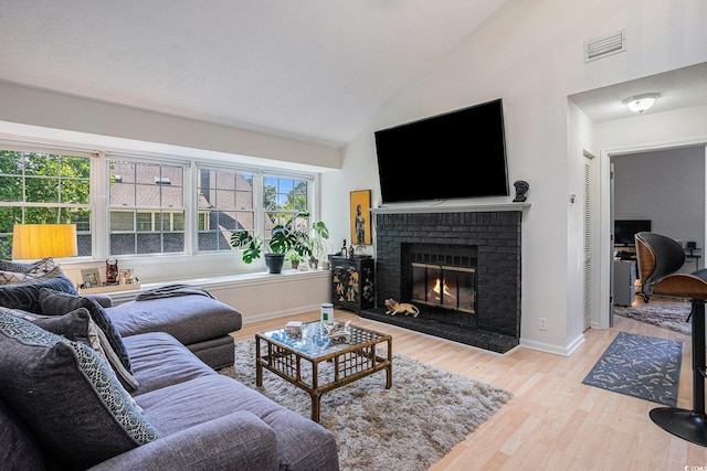 1205 Erin Way Unit 5C, Myrtle Beach, SC 29577 - living area featuring wood finished floors, a brick fireplace, and high vaulted ceiling