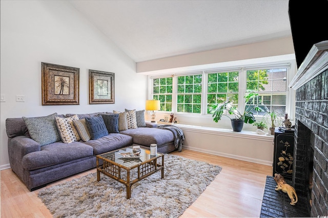 1205 Erin Way Unit 5C, Myrtle Beach, SC 29577 - living area featuring wood finished floors, healthy amount of natural light, a fireplace, and high vaulted ceiling