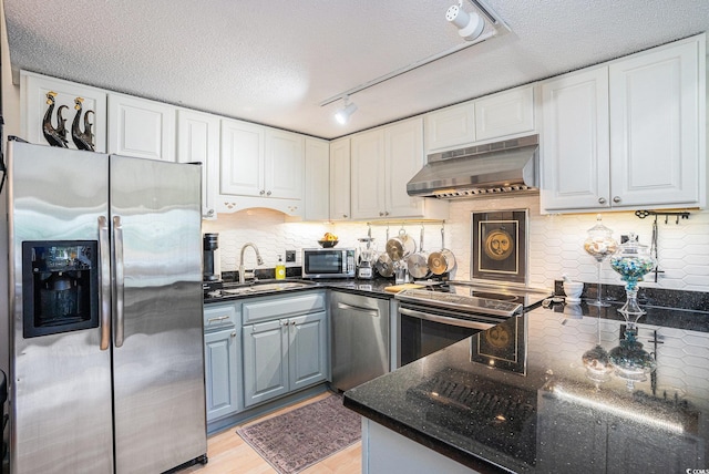 1205 Erin Way Unit 5C, Myrtle Beach, SC 29577 - kitchen featuring appliances with stainless steel finishes, under cabinet range hood, white cabinets, track lighting, and a textured ceiling