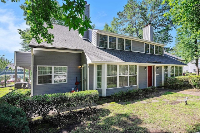 1205 Erin Way Unit 5C, Myrtle Beach, SC 29577 - view of front of house with a chimney, roof with shingles, and a front yard