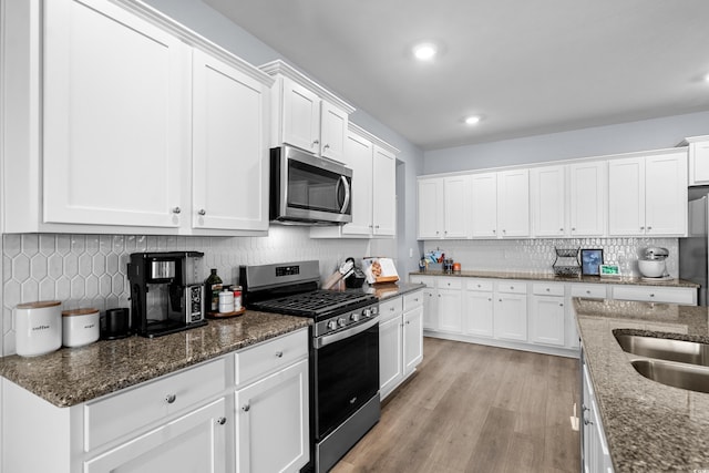 215 Kendrick St, Little River, SC 29566 - kitchen featuring stainless steel appliances, decorative backsplash, white cabinets, light wood finished floors, and recessed lighting