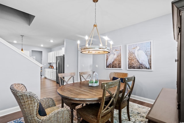 215 Kendrick St, Little River, SC 29566 - dining space with a chandelier, dark wood-type flooring, recessed lighting, and stairs
