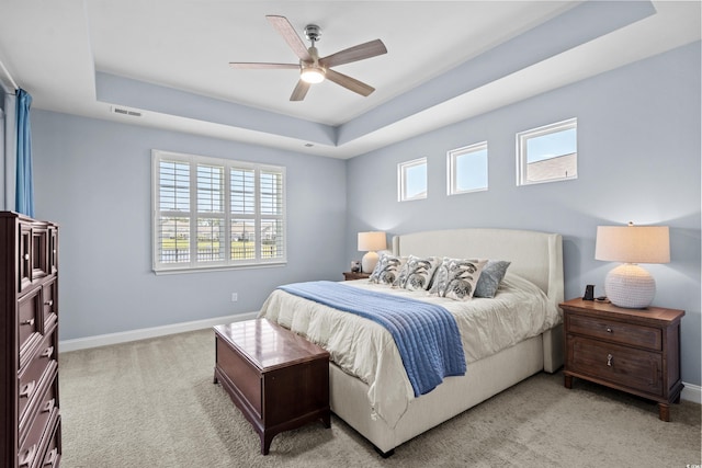 215 Kendrick St, Little River, SC 29566 - bedroom with a tray ceiling, light carpet, and a ceiling fan