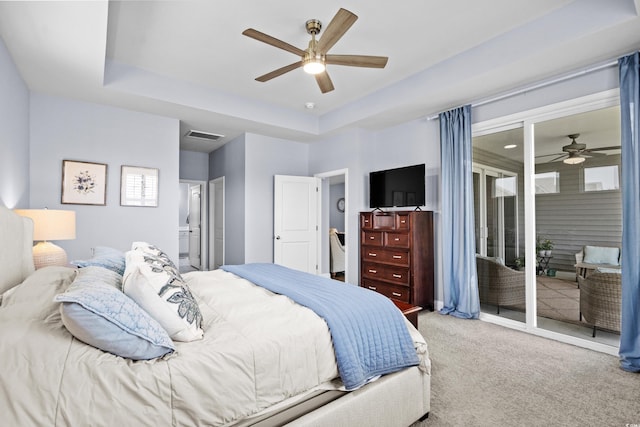 215 Kendrick St, Little River, SC 29566 - carpeted bedroom with access to exterior, a tray ceiling, ensuite bathroom, and ceiling fan