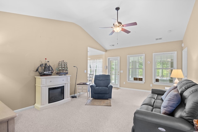 4554 Fringetree Dr, Murrells Inlet, SC 29576 - living room featuring vaulted ceiling, ceiling fan, carpet flooring, and a glass covered fireplace