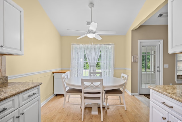 4554 Fringetree Dr, Murrells Inlet, SC 29576 - dining area featuring light wood-type flooring, a wainscoted wall, and a ceiling fan