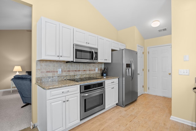 4554 Fringetree Dr, Murrells Inlet, SC 29576 - kitchen featuring appliances with stainless steel finishes, white cabinets, tasteful backsplash, light wood finished floors, and light stone countertops