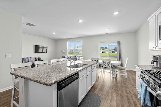 2106 Ainsley Dr, Little River, SC 29566 - kitchen featuring stainless steel appliances, dark wood-style floors, white cabinetry, light stone countertops, and recessed lighting