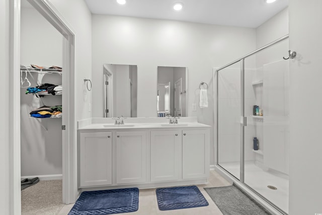 2106 Ainsley Dr, Little River, SC 29566 - full bath featuring a shower stall, double vanity, a walk in closet, and recessed lighting