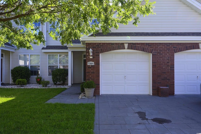 1984 Green Fern Ln Unit 1984, Myrtle Beach, SC 29579 - view of front of home with concrete driveway, brick siding, a front yard, and roof with shingles