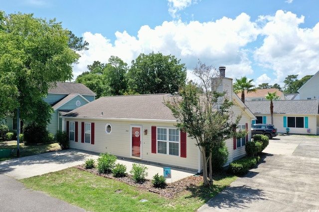 950 Tiffany Ln, North Myrtle Beach, SC 29582 - view of front facade with concrete driveway and a chimney