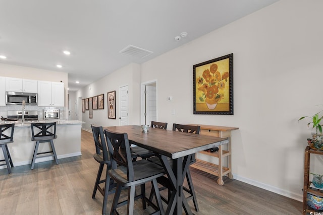 1029 Saltgrass Way, Myrtle Beach, SC 29588 - dining area with dark wood-type flooring and recessed lighting