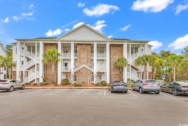 118 Birch N Coppice Dr Unit 2, Surfside Beach, SC 29575 - view of building exterior with uncovered parking and stairway