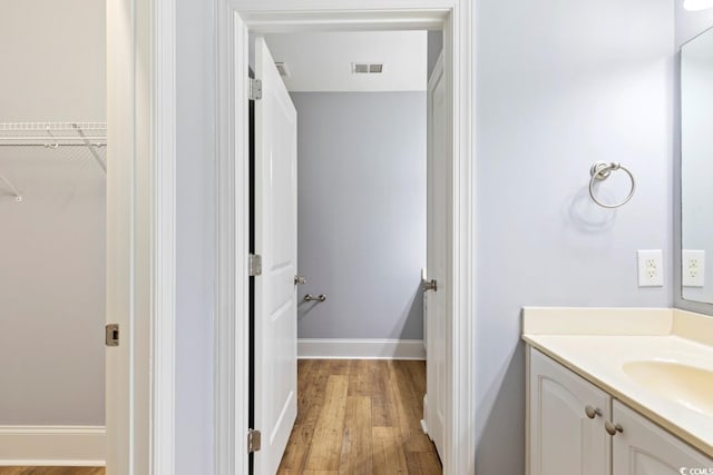 118 Birch N Coppice Dr Unit 2, Surfside Beach, SC 29575 - bathroom featuring vanity, wood finished floors, and a spacious closet