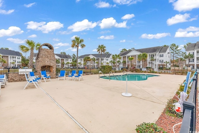 118 Birch N Coppice Dr Unit 2, Surfside Beach, SC 29575 - community pool with a residential view, a multi sided fireplace, and a patio area