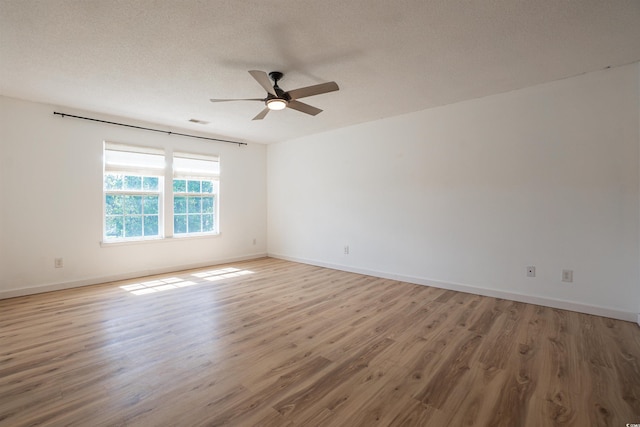 1897 Mossberg Dr, Sumter, SC 29150 - empty room with wood finished floors, ceiling fan, and a textured ceiling