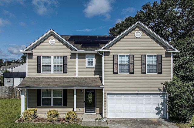 1897 Mossberg Dr, Sumter, SC 29150 - view of front of house with covered porch, roof mounted solar panels, an attached garage, roof with shingles, and concrete driveway