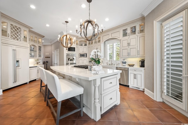 100 Ocean Park Loop, Georgetown, SC 29440 - kitchen with built in appliances, a chandelier, light countertops, a kitchen island with sink, and dark tile patterned flooring