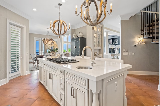 100 Ocean Park Loop, Georgetown, SC 29440 - kitchen featuring stainless steel gas cooktop, a chandelier, ornamental molding, a center island with sink, and light tile patterned floors