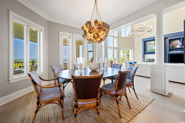 100 Ocean Park Loop, Georgetown, SC 29440 - dining room featuring a chandelier, light wood-style flooring, ornate columns, and ornamental molding