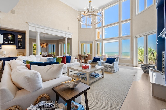 100 Ocean Park Loop, Georgetown, SC 29440 - living area featuring a chandelier, a high ceiling, healthy amount of natural light, ornate columns, and ornamental molding