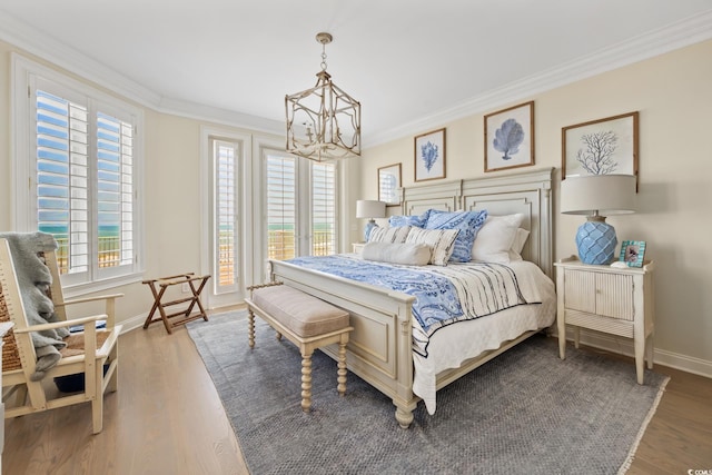 100 Ocean Park Loop, Georgetown, SC 29440 - bedroom featuring a chandelier, crown molding, wood finished floors, and access to exterior