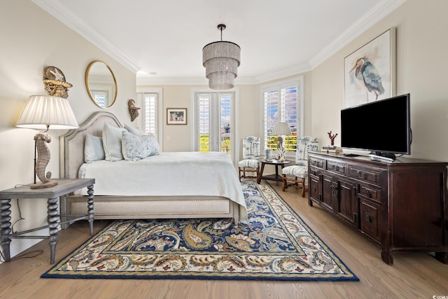 100 Ocean Park Loop, Georgetown, SC 29440 - bedroom with crown molding, a chandelier, light wood-style floors, and access to exterior