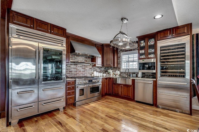 1473 Basin Trl, Murrells Inlet, SC 29576 - kitchen with premium appliances, ventilation hood, wine cooler, a textured ceiling, and light wood finished floors