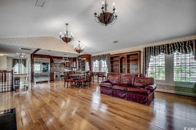 1473 Basin Trl, Murrells Inlet, SC 29576 - living area with a chandelier, light wood-style flooring, and lofted ceiling