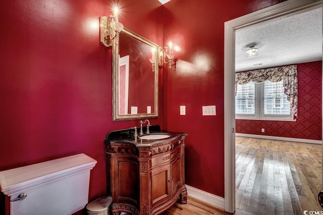 1473 Basin Trl, Murrells Inlet, SC 29576 - bathroom with wood finished floors, vanity, wallpapered walls, and a textured ceiling