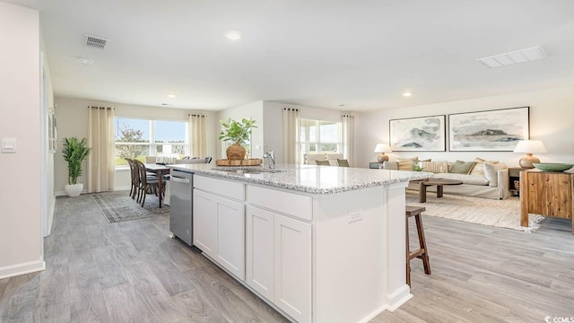 141 Dagger Ct, Myrtle Beach, SC 29588 - kitchen featuring stainless steel dishwasher, healthy amount of natural light, light stone counters, light wood-type flooring, and recessed lighting
