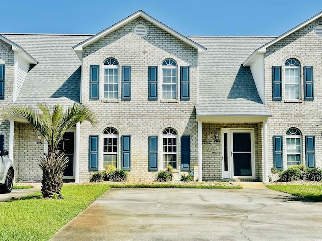 3978 Tybre Downs Cir Unit 3978, Little River, SC 29566 - view of front facade featuring a shingled roof and brick siding