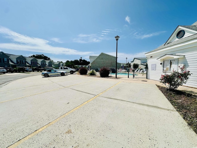 3978 Tybre Downs Cir Unit 3978, Little River, SC 29566 - uncovered parking lot featuring a community pool and a residential view