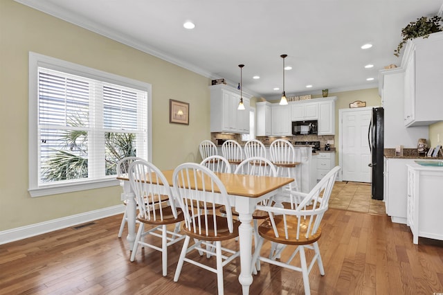 421 30th Ave S, Sunset Beach, NC 28468 - dining space featuring crown molding, light wood finished floors, and recessed lighting