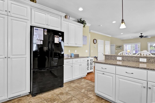 421 30th Ave S, Sunset Beach, NC 28468 - kitchen featuring freestanding refrigerator, a ceiling fan, white cabinetry, ornamental molding, and decorative light fixtures