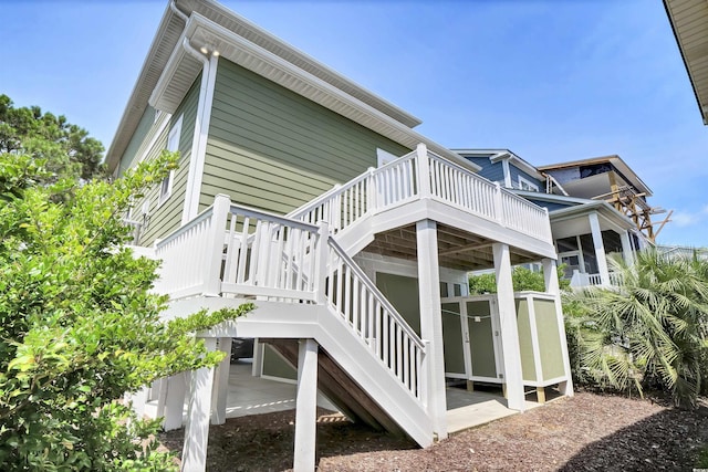 421 30th Ave S, Sunset Beach, NC 28468 - view of side of property featuring a wooden deck and stairs