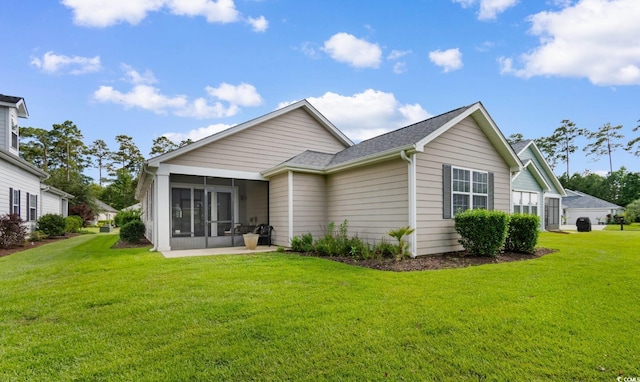 637 Grand Cypress Way, Murrells Inlet, SC 29576 - rear view of house featuring a sunroom, a lawn, and roof with shingles