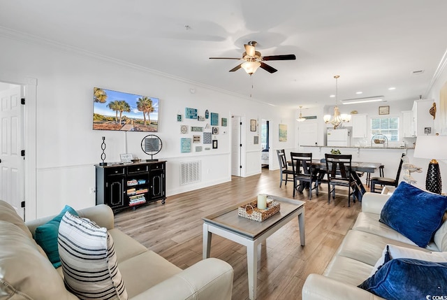 4821 Luster Leaf Cir Unit 202, Myrtle Beach, SC 29577 - living room featuring ceiling fan, ornamental molding, recessed lighting, light wood-style flooring, and a chandelier