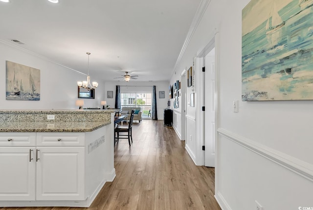 4821 Luster Leaf Cir Unit 202, Myrtle Beach, SC 29577 - kitchen with white cabinets, ornamental molding, decorative light fixtures, light stone countertops, and a chandelier