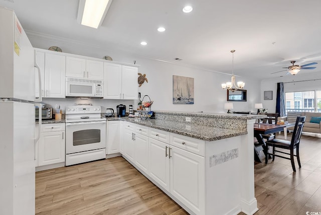 4821 Luster Leaf Cir Unit 202, Myrtle Beach, SC 29577 - kitchen with white appliances, a peninsula, open floor plan, light wood-style flooring, and recessed lighting