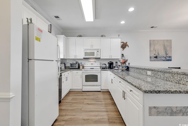 4821 Luster Leaf Cir Unit 202, Myrtle Beach, SC 29577 - kitchen featuring white appliances, a peninsula, white cabinetry, ornamental molding, and stone counters