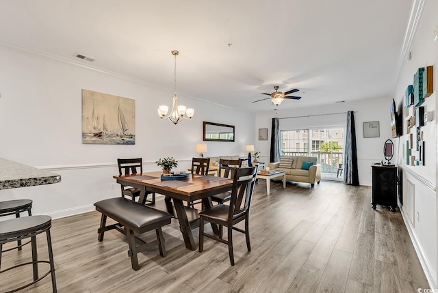 4821 Luster Leaf Cir Unit 202, Myrtle Beach, SC 29577 - dining space with light wood-type flooring, ceiling fan, ornamental molding, and a chandelier