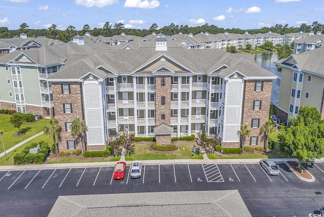 4821 Luster Leaf Cir Unit 202, Myrtle Beach, SC 29577 - view of property featuring uncovered parking and a residential view