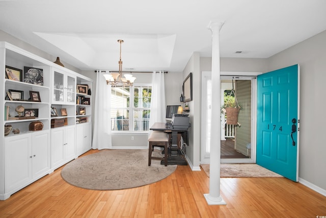 174 Edward Ave, Murrells Inlet, SC 29576 - foyer featuring a raised ceiling, light wood-type flooring, a chandelier, and decorative columns